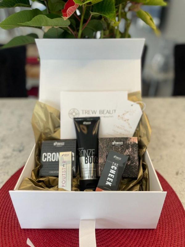 Example gift box from Trew Beauty in white box with gold tissue paper, white ribbon and 5 x BPerfect products with a gift voucher